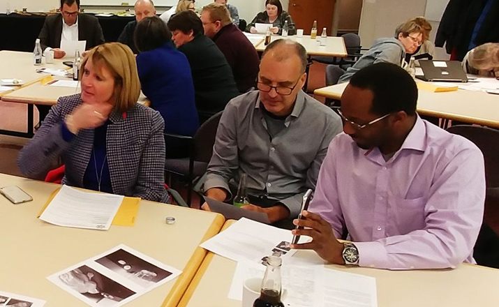 a group of colleagues doing a clue murder mystery intern team building activity