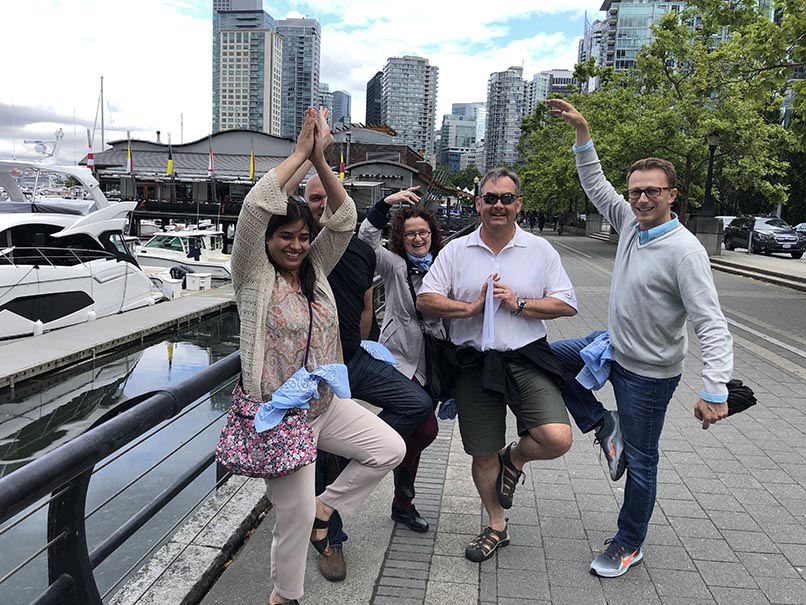 a group of colleagues playing wild goose chase scavenger hunt team building activity
