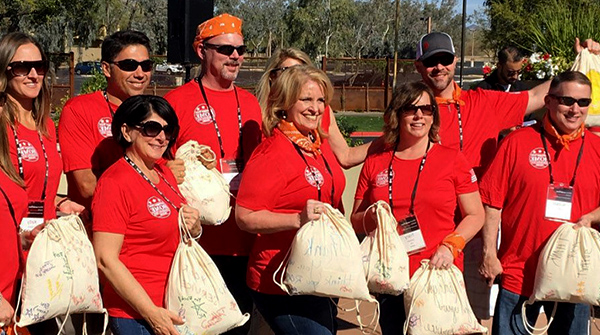 a group of employees doing a military support mission for the troops as part of their volunteer program
