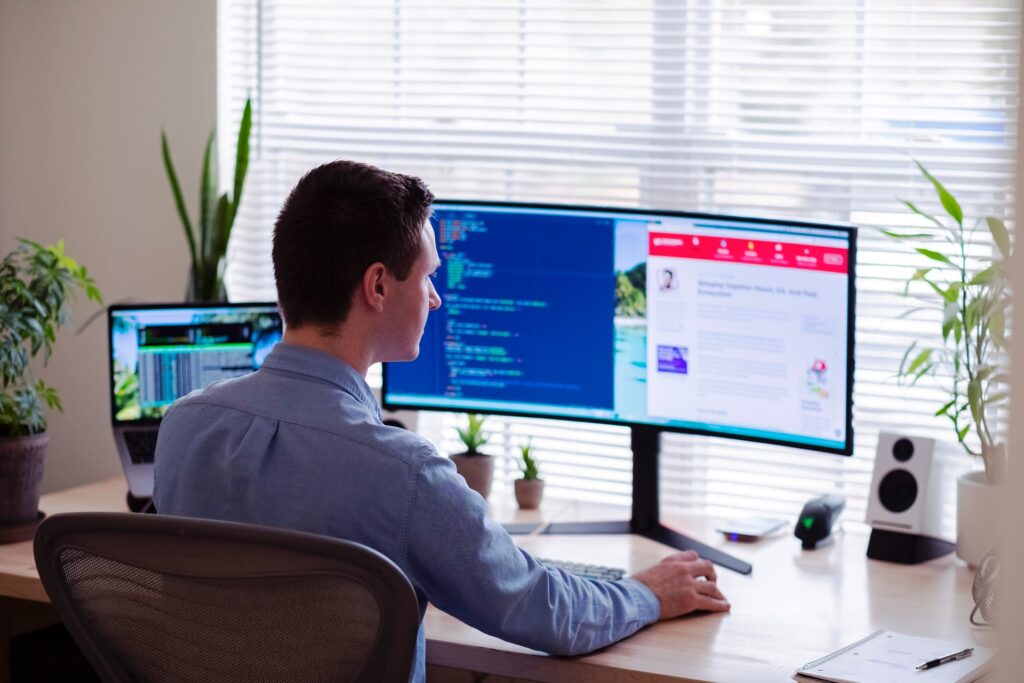 a man using a computer and software tools to engage with his remote team