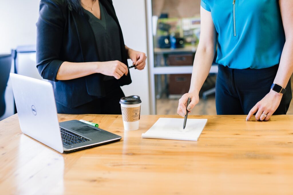 a manager who is micromanaging a team member while looking at work together