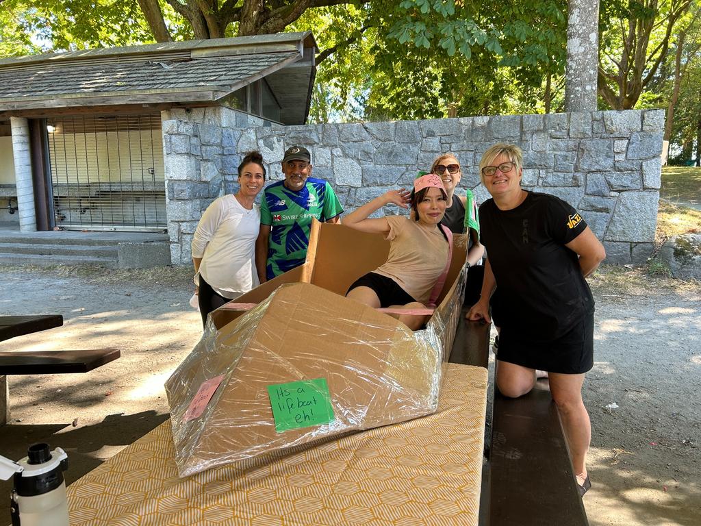 a team doing a cardboard boat building team building activity in boston