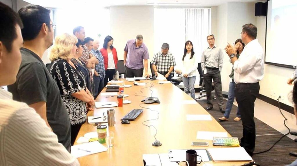 a team of employees at a conference practical time management training for administrative professionals day