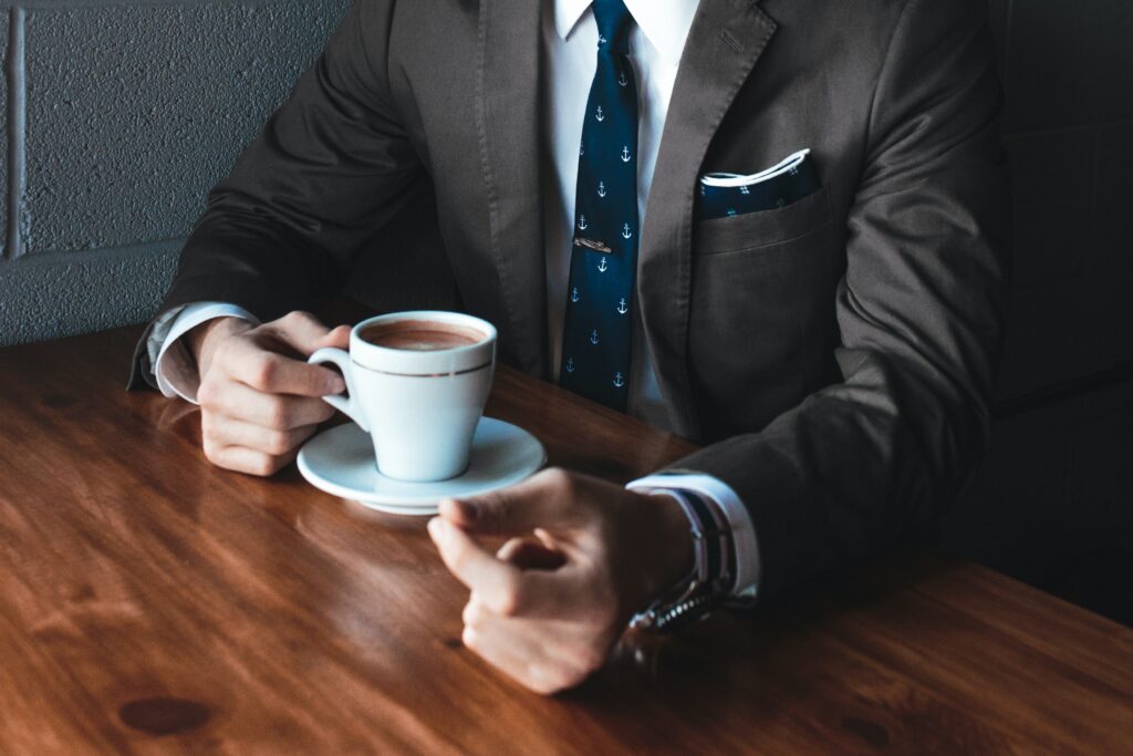 Debatable icebreaker questions section image with person having conversation while drinking coffee