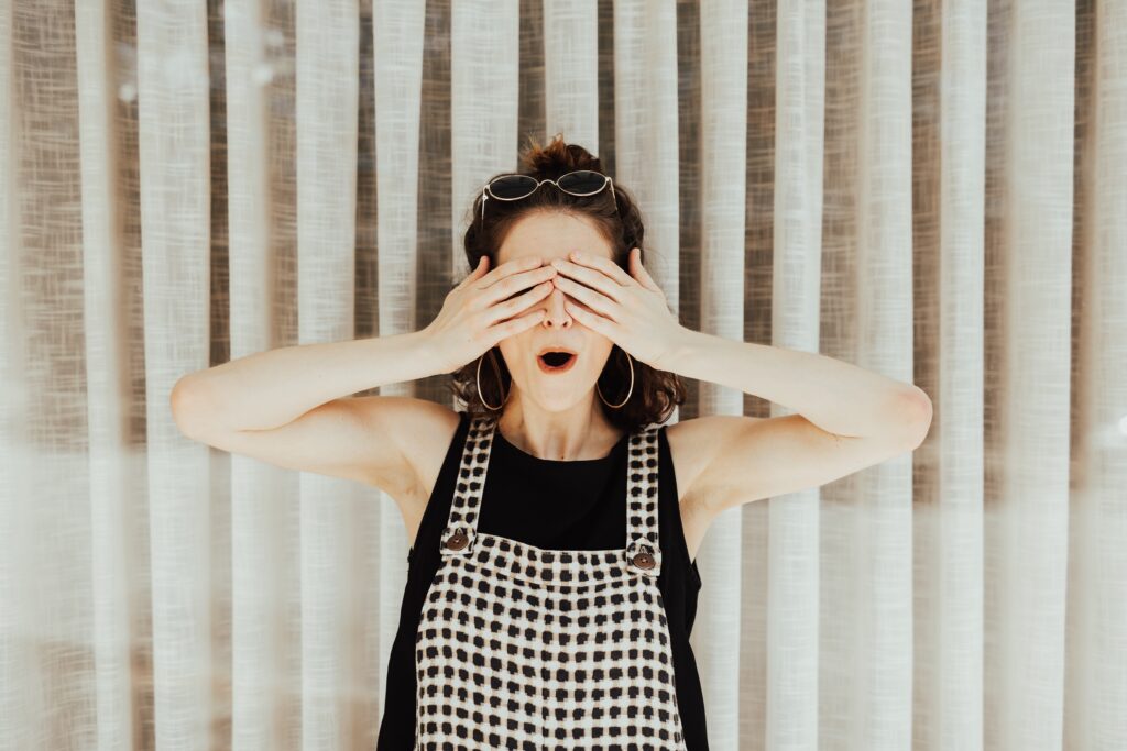Weird team building questions section image with lady covering her eyes