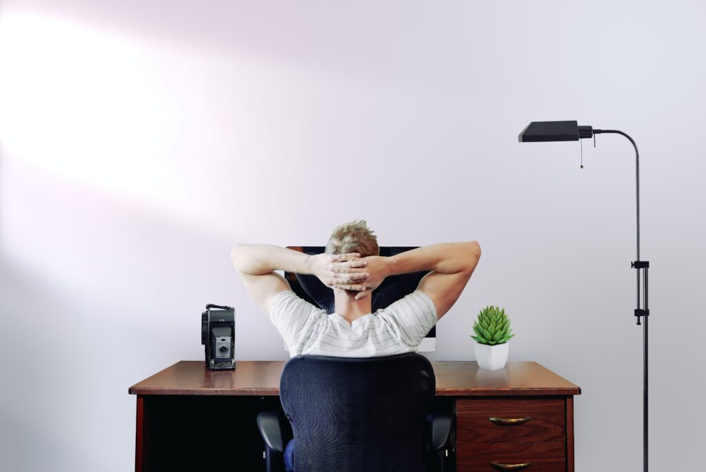 Unique icebreaker questions section image with guy sitting relaxed on his laptop