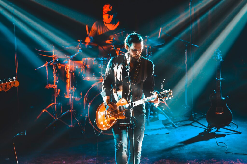 Pop-culture themed ice breaker questions section image with rock star performing on stage