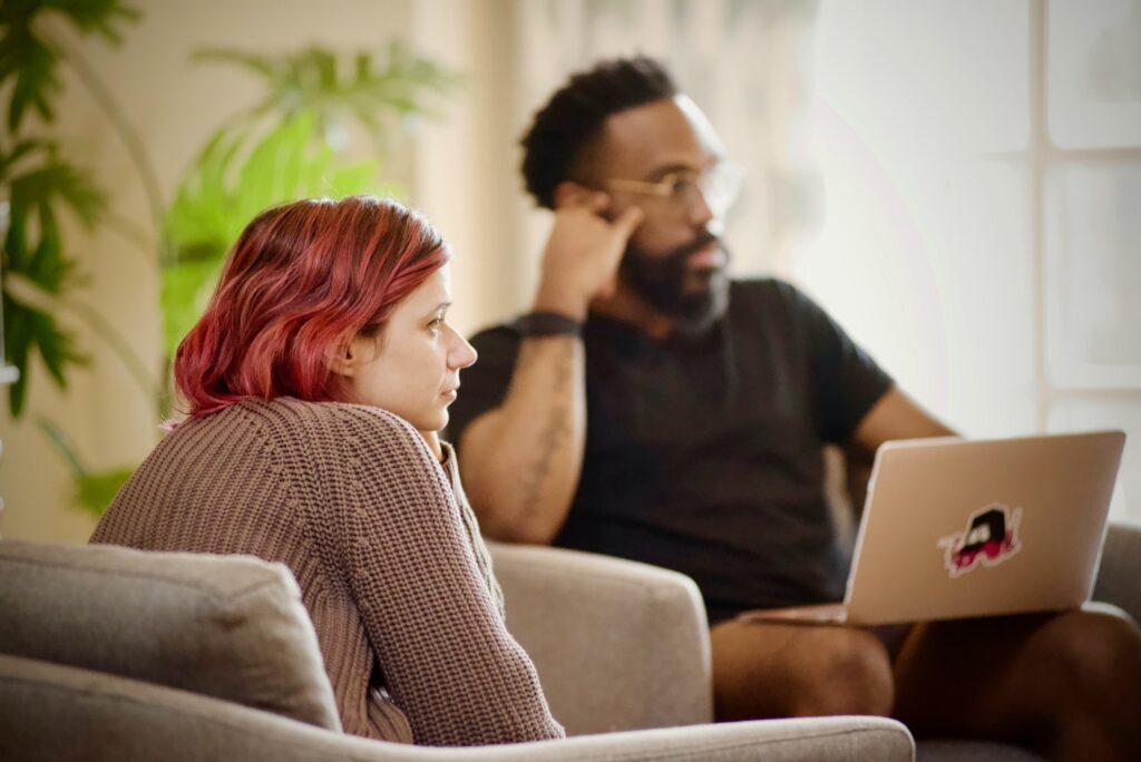 two colleagues in a meeting actively listening to someone